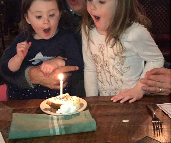 children blowing out birthday candle 