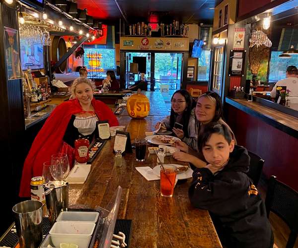 Photo of employees in Halloween costumes-  Sammy, Isa