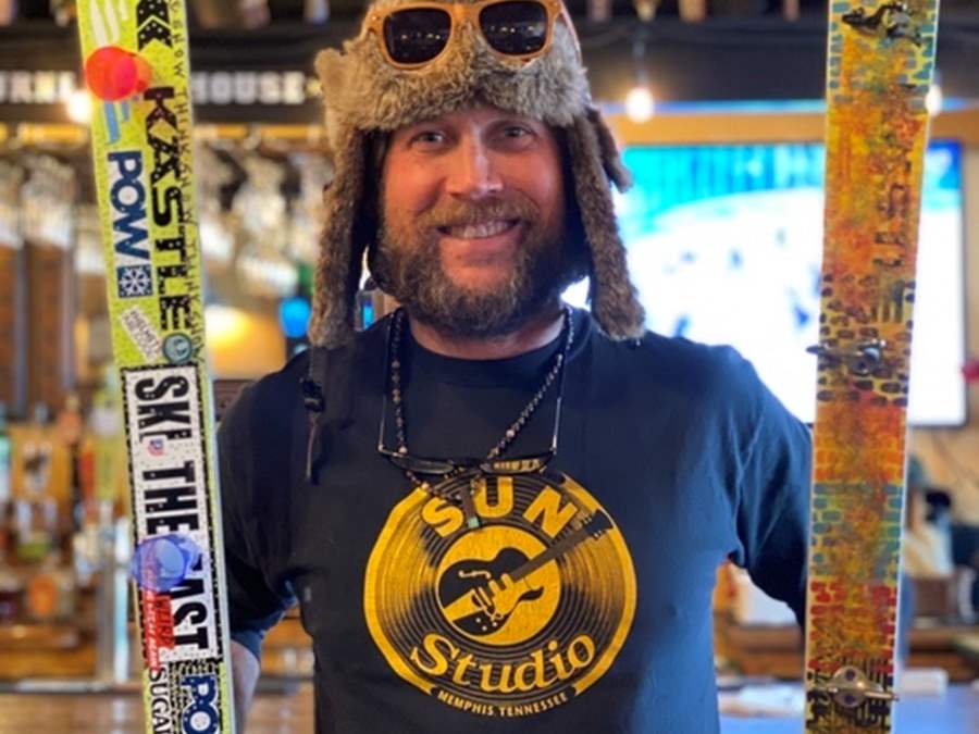 Guy with artwork on ski for fundraiser