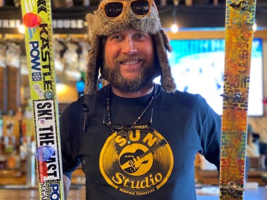 Guy with artwork on ski for fundraiser 