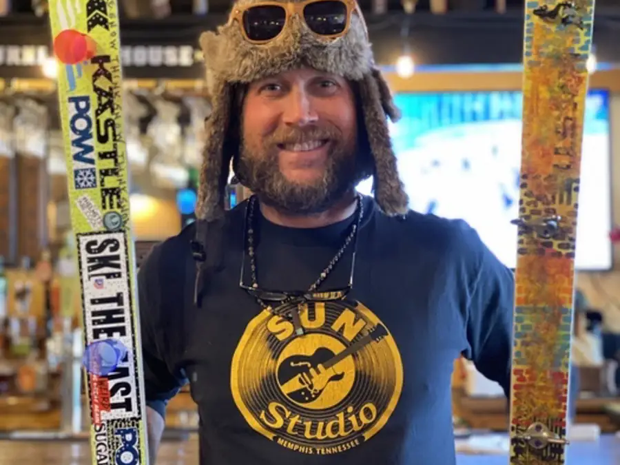 Guy with artwork on ski for fundraiser 