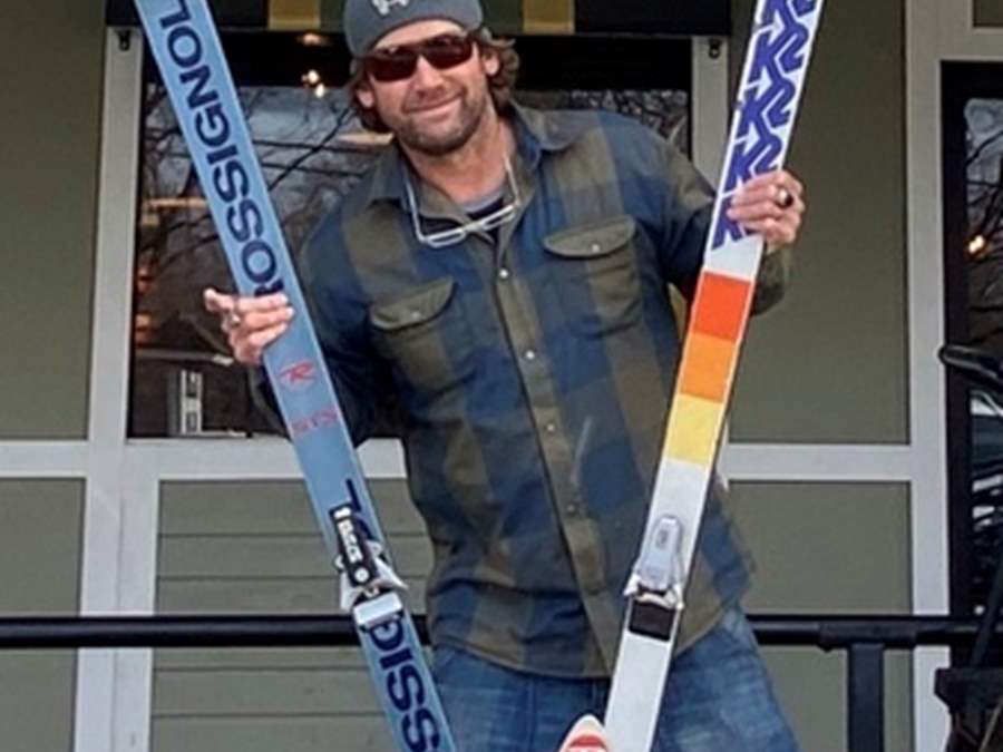 Photo of man holding skis for fundraiser